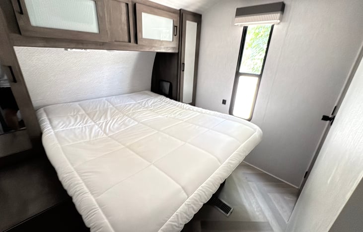 Master bedroom with queen size bed and plenty of storage.