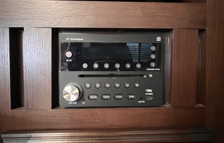 Radio, CD, DVD player with inside and/or outside speakers.