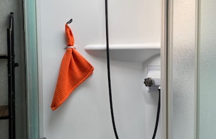 Shower with skylight and built-in shelf.