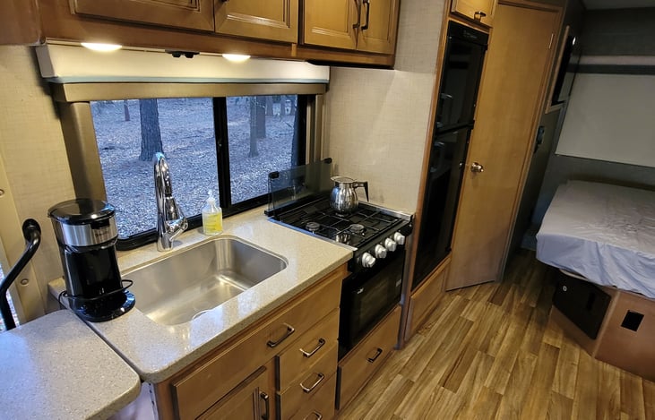 Kitchen Area with bathroom door in view.