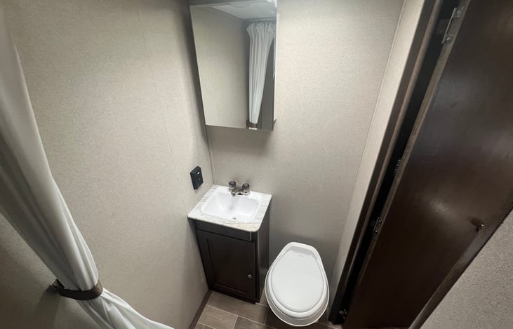 Clean bathroom with shower, vanity and toilette.