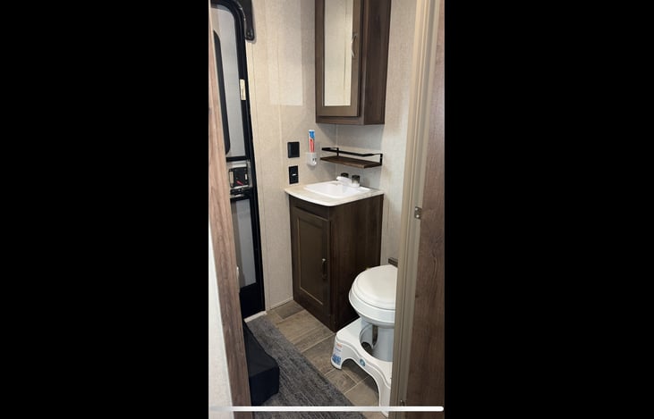 Hallway half bath with door to the outside.