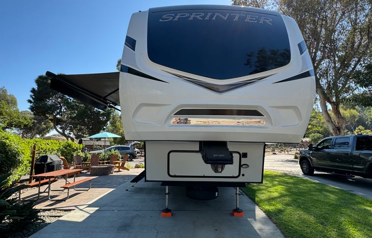 Front view of the RV in a beautiful campsite!