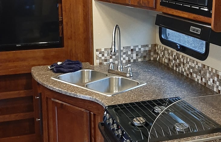 good picture galley stove and oven, two bin sink and hot and cold water on tap, microwave too.