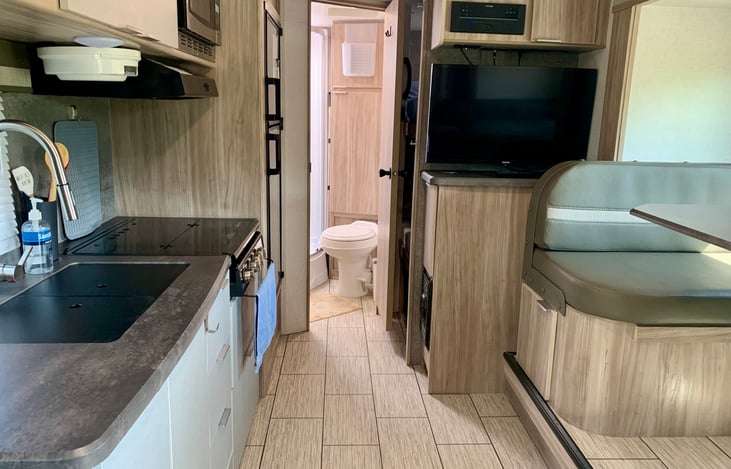 From the front of the trailer looking back. Bunk beds are behind open bathroom door.