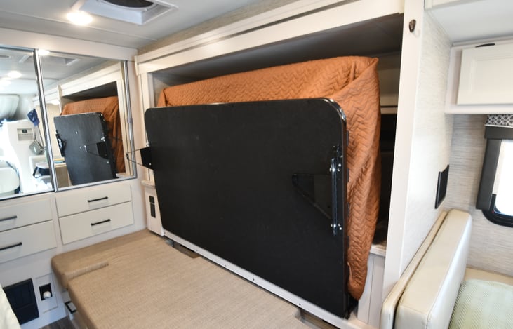 Main bed folded up (gives sitting area in front of TV while slide out)