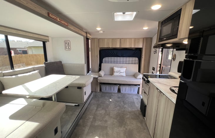 View of the living space with dinette, couch, and kitchen.