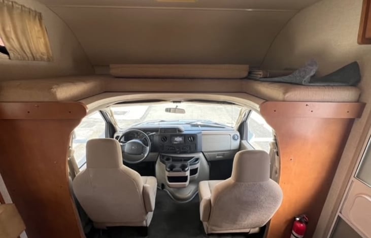 Over the drivers seat, makes a bed that's able to sleep two