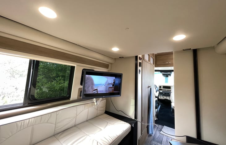 The opposing ultra leather couches create for a nice living space with slide open windows. The LG flat screen TV and Fusion sound system adds to the lounging experience.