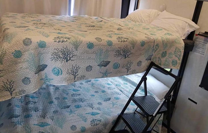 Sitting room converted into sleeping area with two queen beds.