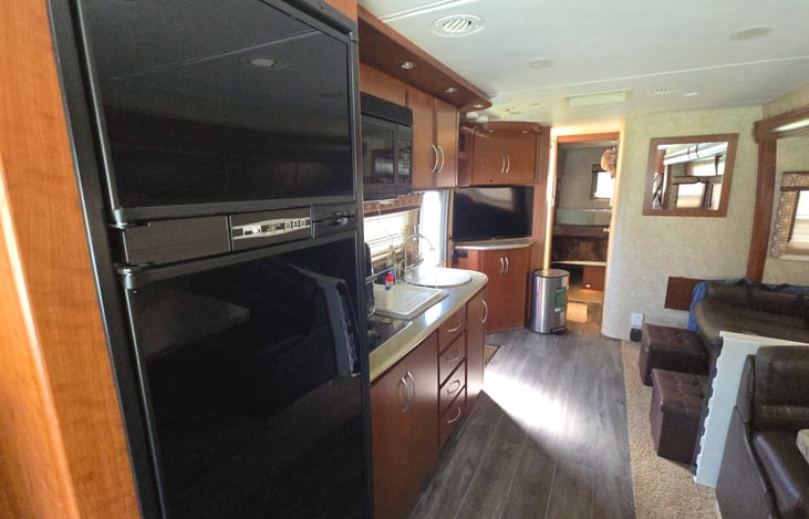 LP gas/electric refrigerator with auto feature.