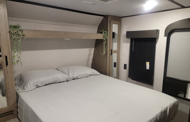 Queen size bed with topper. There are 3 closets and it's own exterior door.