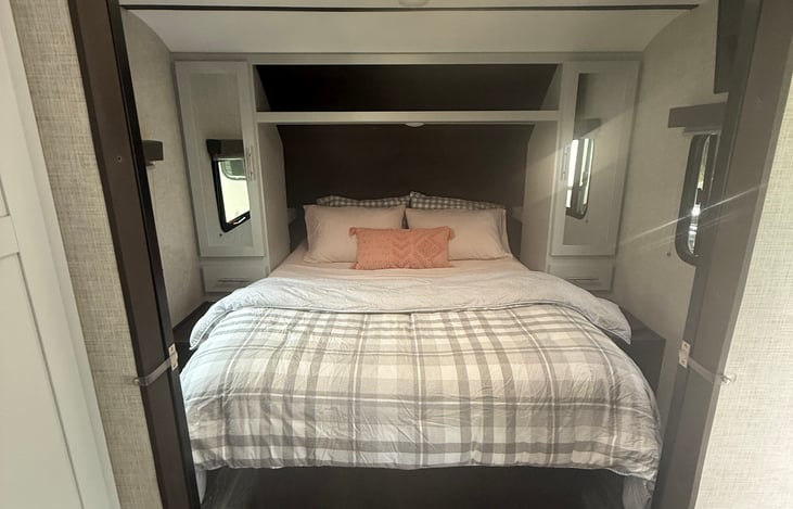 Master Bedroom. Door close for privacy. There are closets and drawers on each side of the bed as well as little lights. There is also a TV in the top corner when you just want to relax alone.