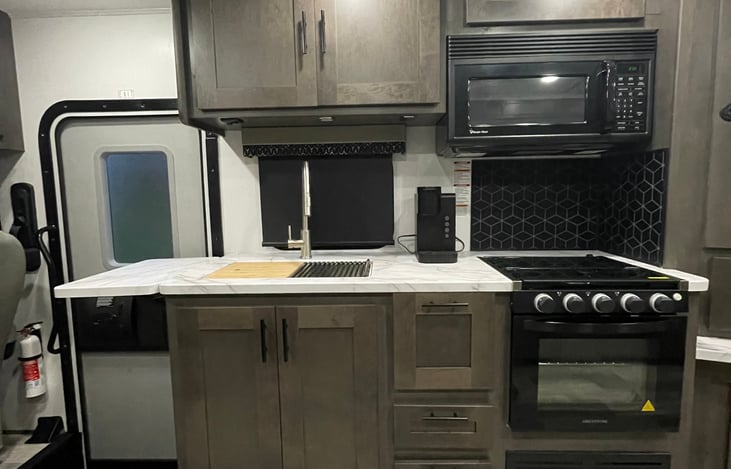 Custom Countertops w/Flip-up & Pullout Countertop Extensions, Stainless Steel Kitchen Sink w/Bamboo Cutting Board & Roll Up Dryer, Trash Can Storage Area Below Sink, 30" Residential OTR Microwave