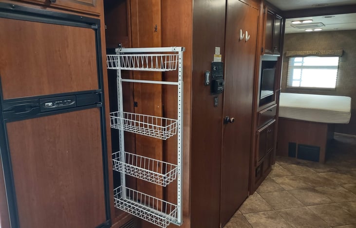 slide out pantry next to fridge, opposite stove area