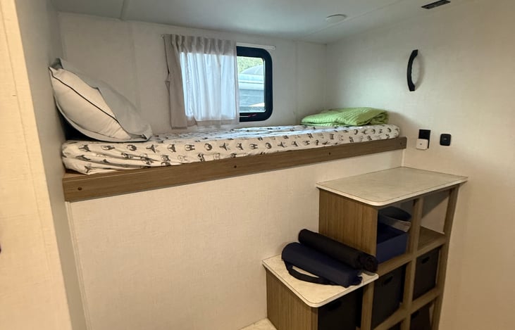 Bunk bed with storage under stairs