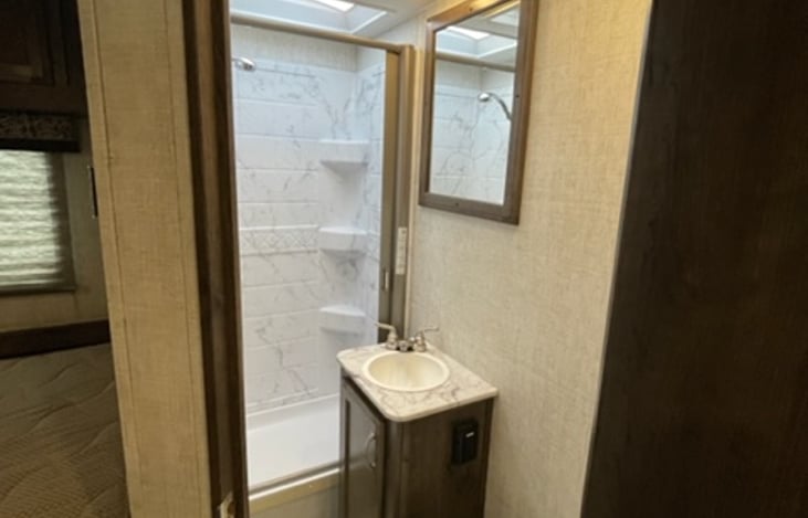 Bathroom with stand up shower, sink and toilet (not shown in photo)