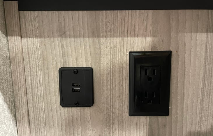 The left side of the bed has 2 USB ports and an electrical outlet.