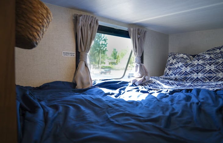 two twin sized bunks equipped with charging outlets provide plenty of sleeping space for the whole family.