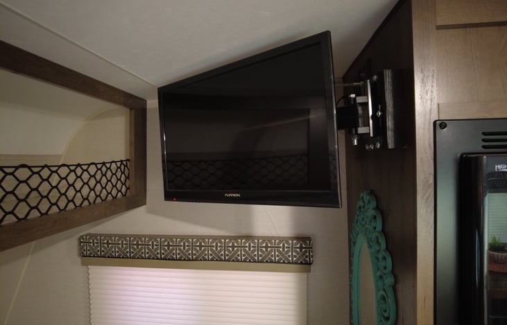 If your campground has either an antenna hook up or WiFi then you will have a TV to watch as you fall asleep. It also swings out to view from the dining table or kitchen.