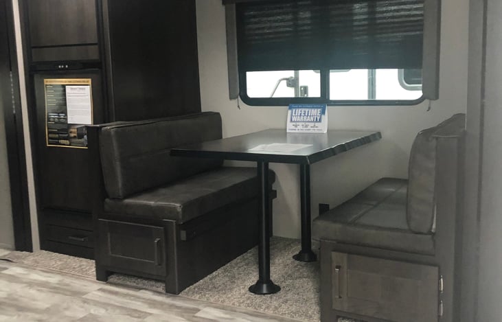 Complete dinette room that comfortably seats 4-6 with small children.  Converts into a bed that sleeps 1-2.  Ample space refrigerator with freezer.