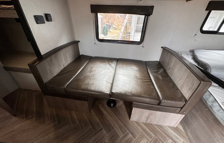 Think of this as a "bed area". While the vinyl couch cushions may not be comfortable to sleep on, it is perfect surface for a dog bed or a sleeper cot for small children.