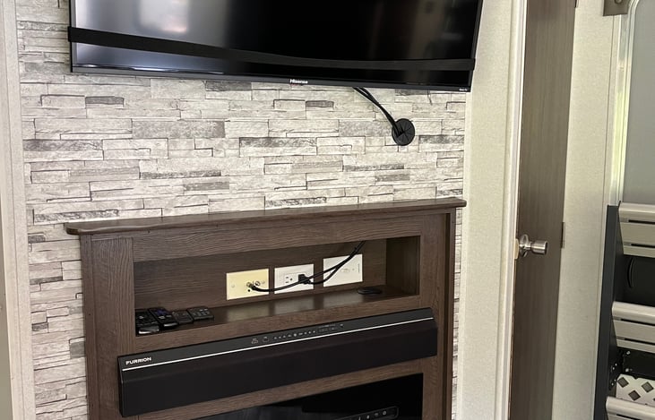 Our awesome entertainment center with a loud sound bar that connects via Bluetooth, aux and also connects to the tv. The electric fireplace also puts off heat in the cold winter mornings!