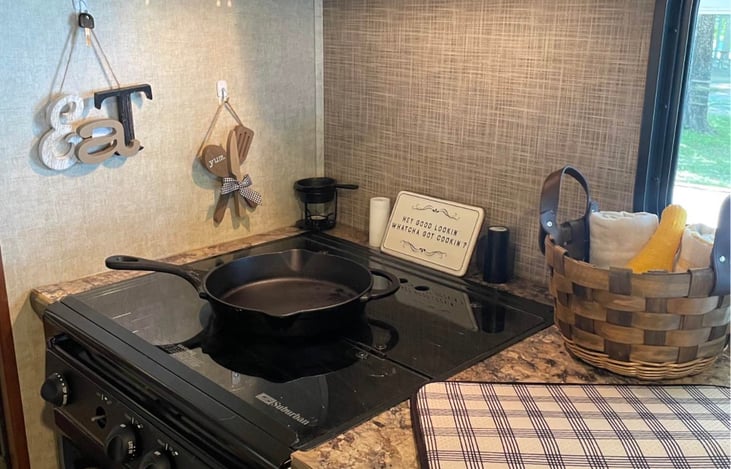 Three burners on stove top and oven