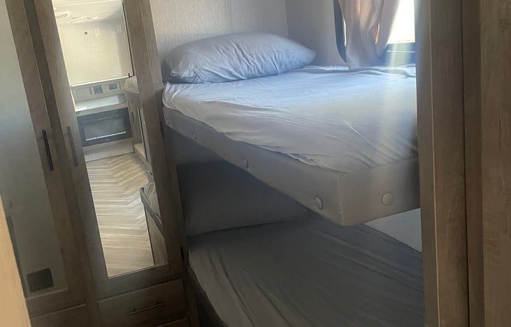 Double bunks on both sides of back room separated by a pocket door