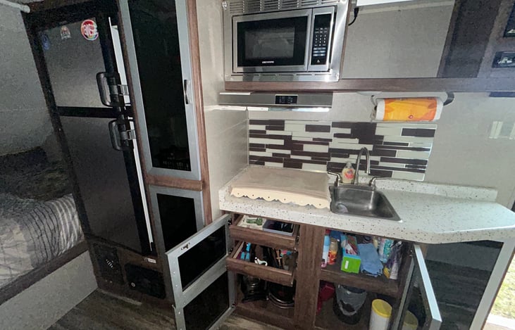 Kitchen - Stocked with eating/cooking utensils, towels, pots & pans, trash bags and basic cleaning supplies.