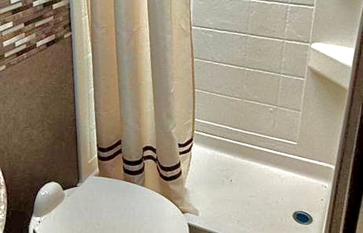 Bathroom stocked with luxury towels, hair dryer, and spa quality products