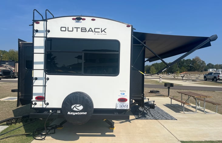 Living room has a large picture window in the back of the RV for great views and an open feeling