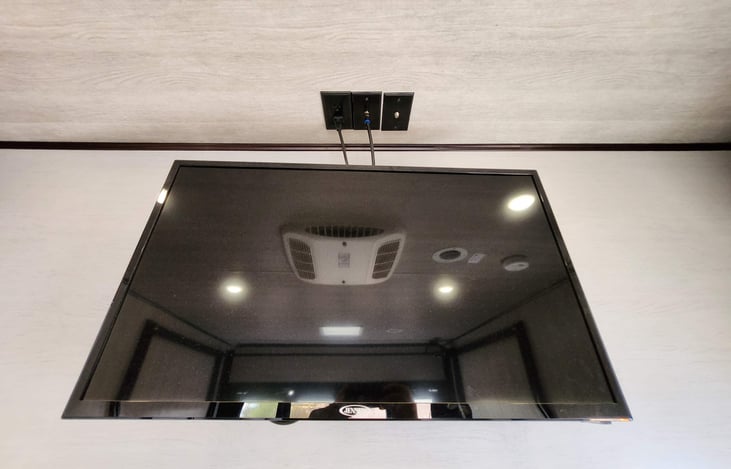 Smart TV with hooks up located in the garage.