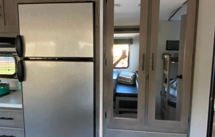 Pantry next to fridge will have basic linens.