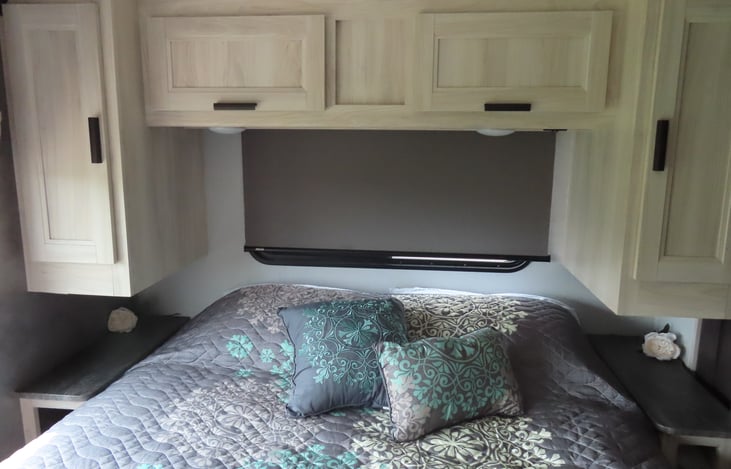 Deluxe master bedroom featuring a comfortable bed, pillows & linens, and plenty of cupboards, drawers and closets.