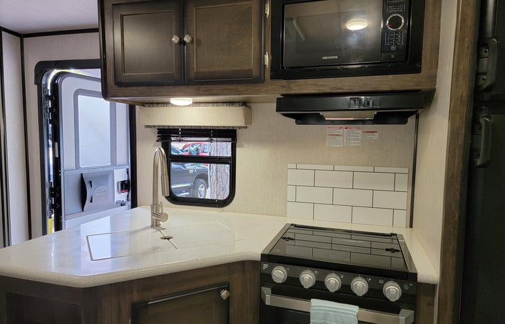 Kitchen including sink, stove, oven, and microwave