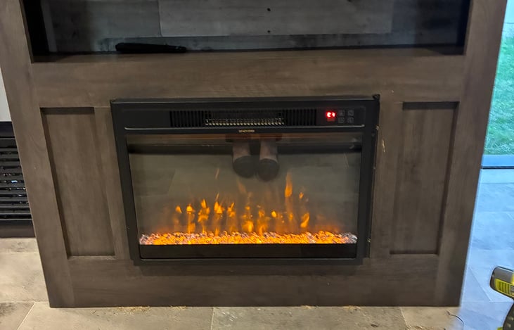 The cozy electric fireplace is wonderful for the cooler nights after enjoying the campfire. Come inside watch a movie and warm up by the fire!🔥