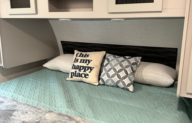 King-sized bed w/ two small closets, overhead, and under-bed storage. Two King-sized pillows, sheets, quilt, and throw included in all rentals.