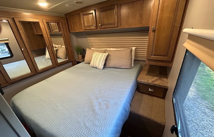 Queen with sliding doors on each side plus closet with ample storage and wall mounted TV