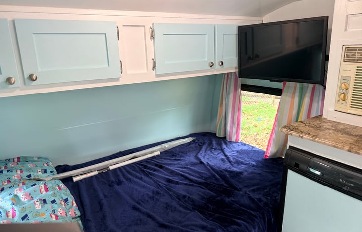 TV rotates 180 degrees. Can be viewed from the dinette, main bed, or both beds.