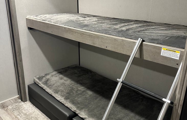 300 lbs approved for top bunk. Can sleep 6 foot adult.