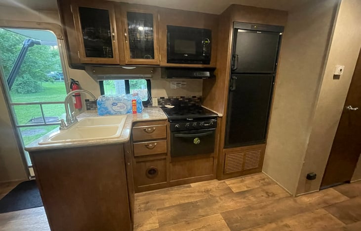 Fridge is auto. will use propane or power when connected. keeps food cold while driving if the prop[ane is on. no need to light any pilot lights.