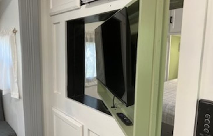 TV swivels around from bedroom to living area