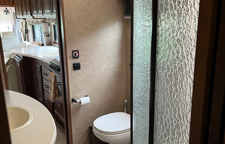 Pass through bathroom off master and kitchen has a large quarter round shower.