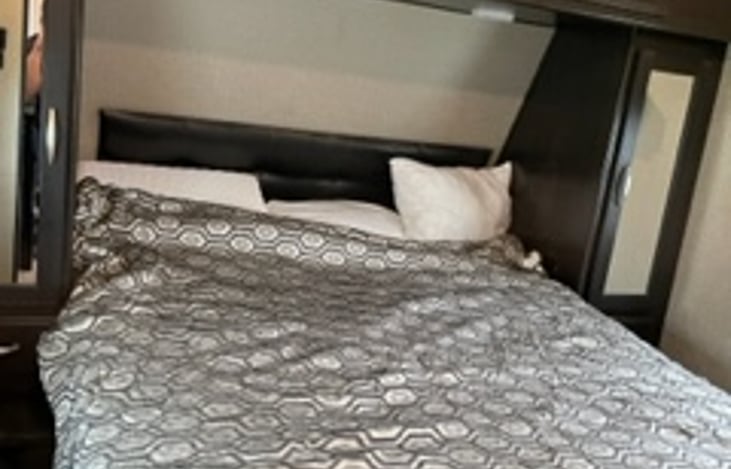 queen sized bed with pillow topper