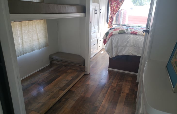 A ton of storage here or fold up the upper bunk and we use this area for a small table and two chairs for a computer office area.