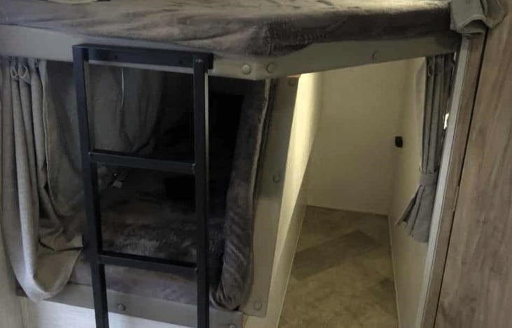 Bunks with bottom bunk folded up for storage