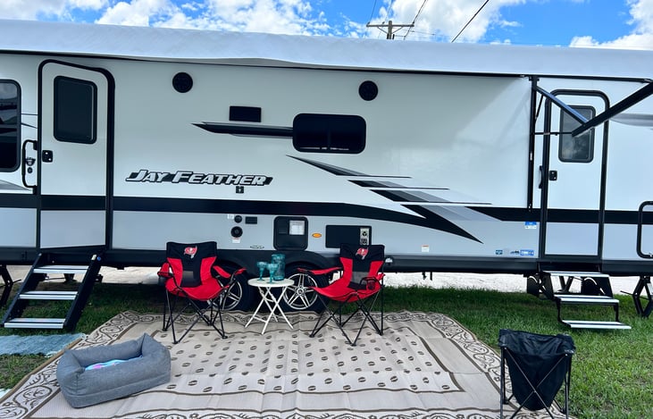 We include the rug and outdoor trash bin for your convenience. Two entrances. One is to the master bedroom. If you need chairs...just ask us!