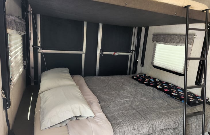 Queen fold out couch on the bottom and queen bunk above.