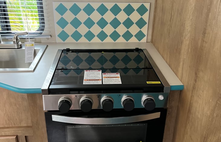 Stove hasn't even been used yet... Here it is with glass fold over cover intact, makes for even more counter space!